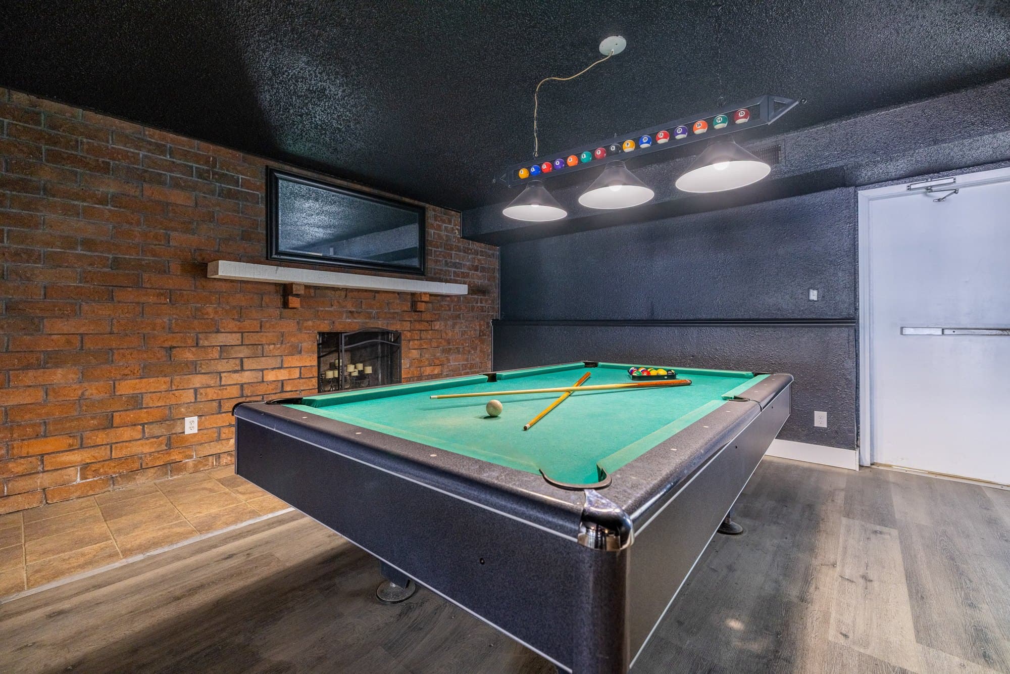 Game room with a pool table at The Grove Apartments in North Peoria
