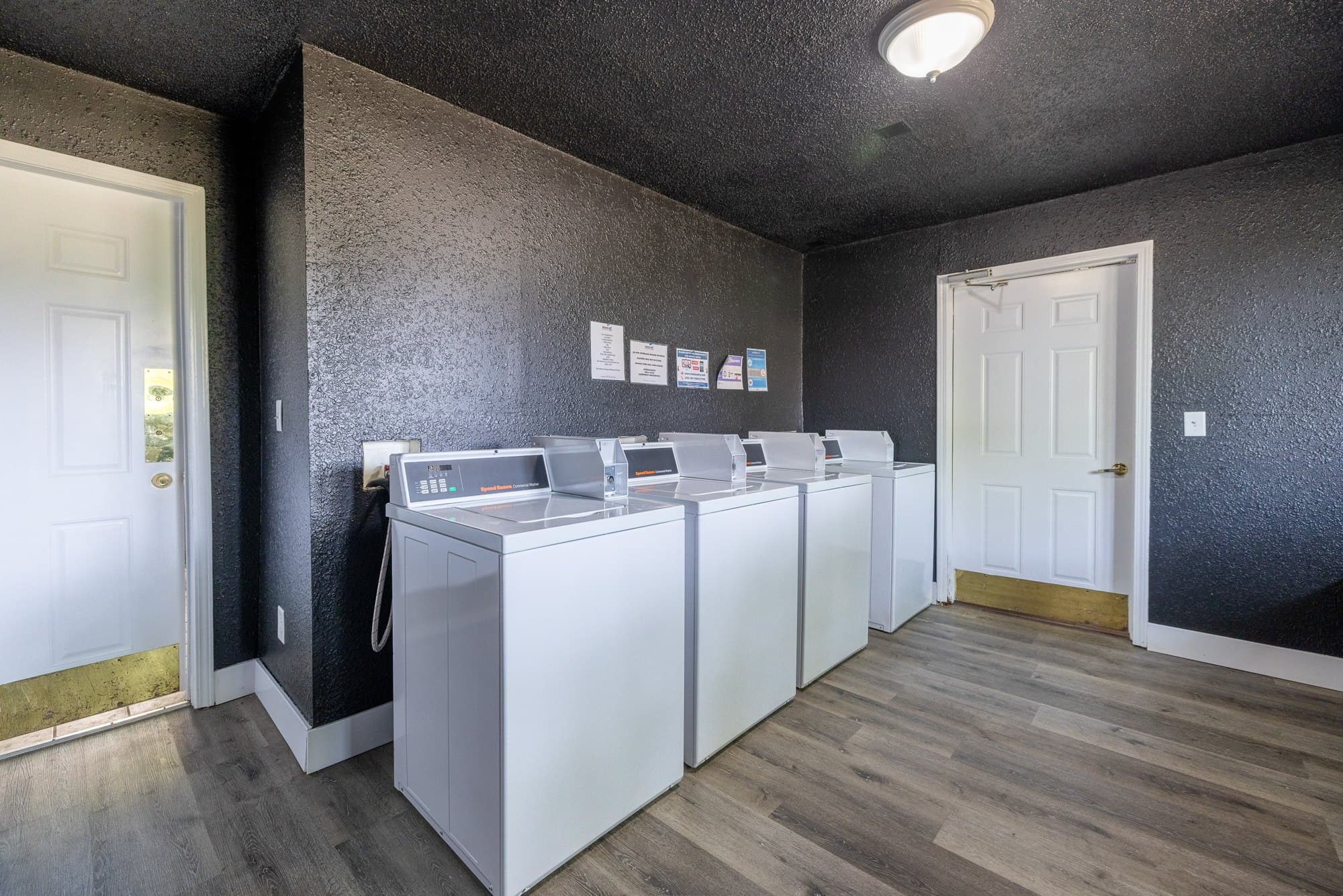 On-site laundry room with washers and dryers at The Grove Apartments